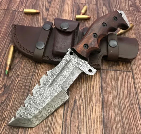 Elevate your outdoor adventure with this hand-forged Damascus steel hunting knife, crafted for serious hunters, survivalists, and knife collectors. Featuring a rugged hammered finish and a razor-sharp edge, this knife is as tough as it is beautiful. Blade Length: 5.5 inches Handle Length: 5 inches (Rosewood Grip with Finger Grooves) Total Length: 10.5 inches Includes: Premium stitched leather sheath Blade Material: Damascus steel, hammered and hand-finished Handle Material: Rosewood with steel rivets and ergonomic grip Purpose: Ideal for hunting, camping, Bush craft, and tactical use Handmade: Each knife is individually hand-crafted Whether you’re in the wild or on display, this knife brings unmatched functionality and craftsmanship. A perfect gift for knife collectors and outdoor enthusiasts! Note: This knife is handmade, so minor variations in texture and finish are part of its uniqueness. Never Sale under 18 year,